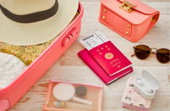 flat lay of travel essentials like passports, bag and boarding pass